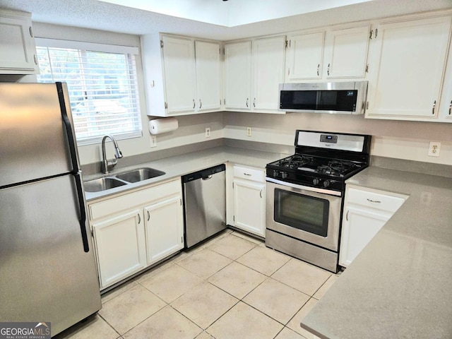 35 Rumson Ct SE, Smyrna, GA 30080 - kitchen with white cabinets, light tile patterned floors, a sink, and appliances with stainless steel finishes