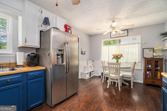 10 Powder Dr, Dallas, GA 30157 - kitchen with stainless steel refrigerator with ice dispenser, a ceiling fan, blue cabinetry, a sink, and healthy amount of natural light