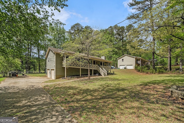 10 Powder Dr, Dallas, GA 30157 - view of grassy yard with stairs, concrete driveway, and an attached garage