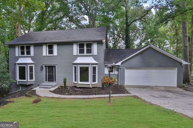9415 Martin Rd, Roswell, GA 30076 - colonial inspired home featuring driveway, a garage, a front yard, and brick siding