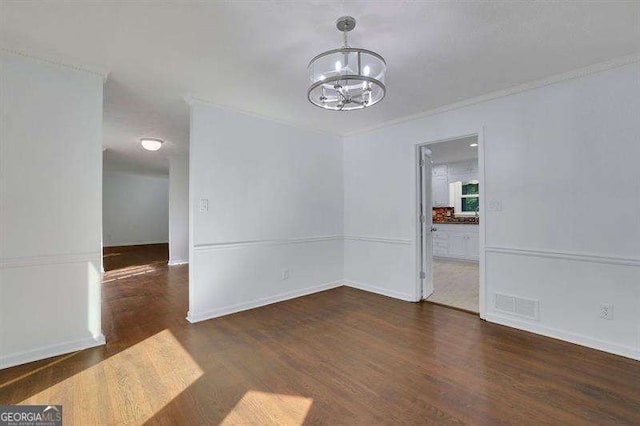 9415 Martin Rd, Roswell, GA 30076 - unfurnished dining area with a chandelier, wood finished floors, and crown molding