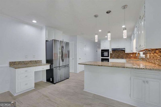 9415 Martin Rd, Roswell, GA 30076 - kitchen featuring freestanding refrigerator, light stone countertops, white cabinetry, decorative backsplash, and a peninsula