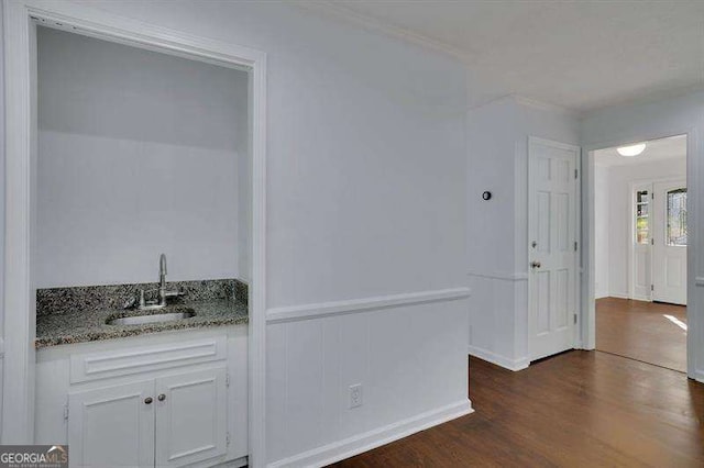 9415 Martin Rd, Roswell, GA 30076 - corridor with dark wood finished floors, a wainscoted wall, and crown molding