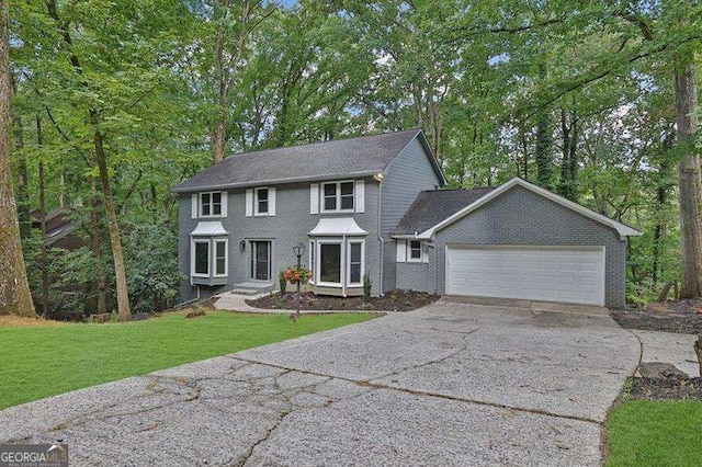 9415 Martin Rd, Roswell, GA 30076 - colonial-style house featuring concrete driveway, a garage, and a front yard