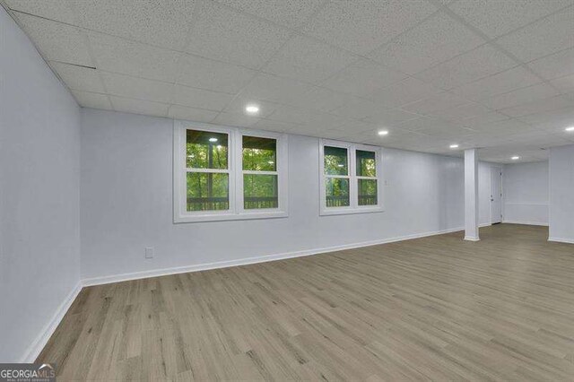 9415 Martin Rd, Roswell, GA 30076 - basement featuring wood finished floors and a paneled ceiling
