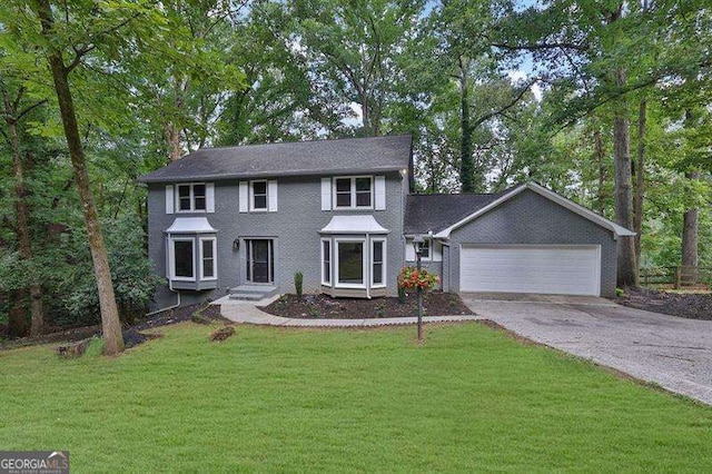 9415 Martin Rd, Roswell, GA 30076 - colonial-style house with driveway, an attached garage, and a front lawn