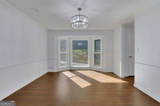 9415 Martin Rd, Roswell, GA 30076 - unfurnished dining area featuring a chandelier, ornamental molding, and wood finished floors