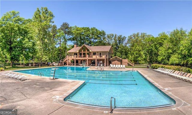 9415 Martin Rd, Roswell, GA 30076 - community pool featuring view of wooded area and a patio area