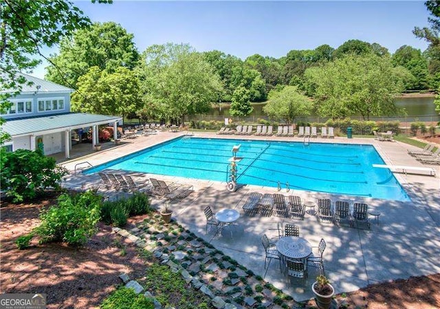 9415 Martin Rd, Roswell, GA 30076 - community pool with a diving board, a patio, and view of scattered trees