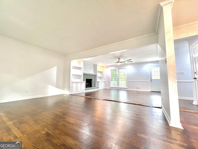 9415 Martin Rd, Roswell, GA 30076 - unfurnished living room featuring ornamental molding, ceiling fan, wood finished floors, and a fireplace