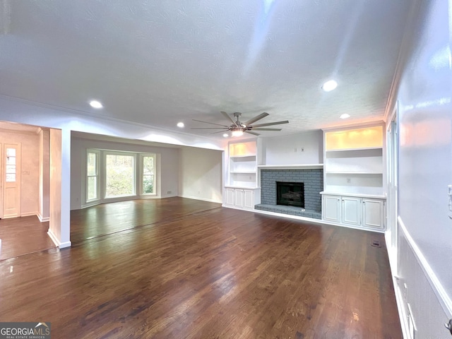 9415 Martin Rd, Roswell, GA 30076 - unfurnished living room with a ceiling fan, dark wood-style floors, a brick fireplace, built in shelves, and recessed lighting