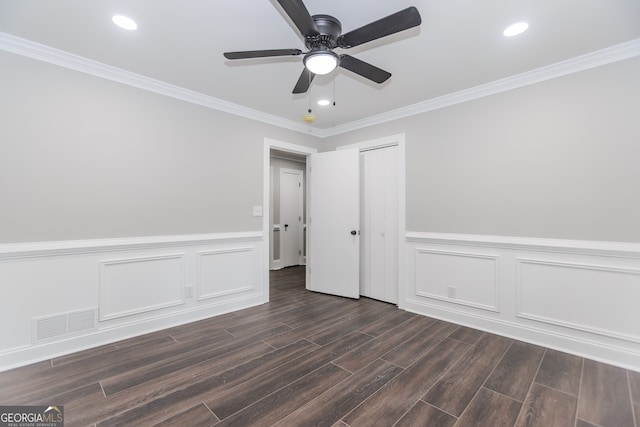 247 Old Timber Rd, Lawrenceville, GA 30046 - empty room featuring a wainscoted wall, crown molding, visible vents, ceiling fan, and dark wood-type flooring
