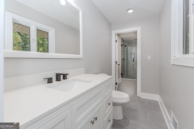 247 Old Timber Rd, Lawrenceville, GA 30046 - full bathroom featuring tile patterned flooring, vanity, toilet, baseboards, and a shower stall