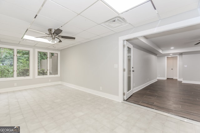 247 Old Timber Rd, Lawrenceville, GA 30046 - empty room with visible vents, baseboards, ceiling fan, tile patterned floors, and a paneled ceiling