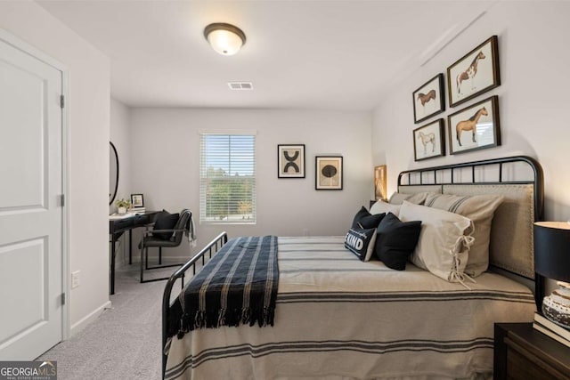 carpeted bedroom with baseboards and visible vents