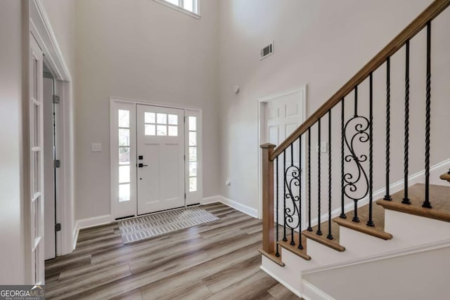 3065 Meadow Springs Dr, Watkinsville, GA 30677 - entryway with wood finished floors, a high ceiling, and stairway