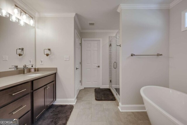 3065 Meadow Springs Dr, Watkinsville, GA 30677 - full bathroom with vanity, a freestanding bath, a stall shower, ornamental molding, and tile patterned flooring