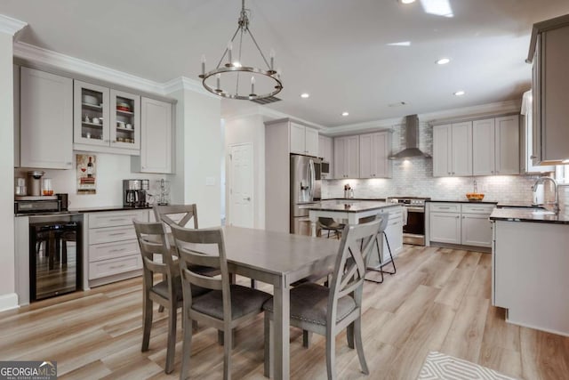 3065 Meadow Springs Dr, Watkinsville, GA 30677 - dining room featuring wine cooler, crown molding, light wood finished floors, a chandelier, and recessed lighting