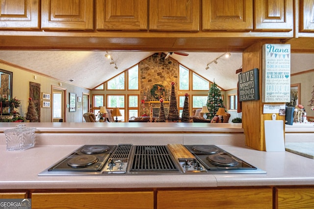 4004 White Oak Ln, Lagrange, GA 30240 - kitchen featuring light countertops, vaulted ceiling, stainless steel electric stovetop, a textured ceiling, and brown cabinets