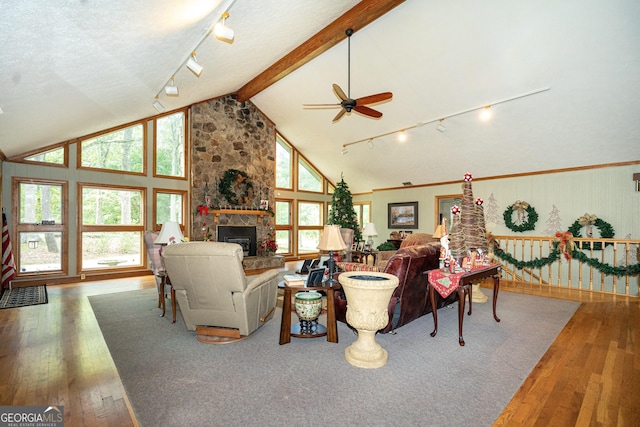 4004 White Oak Ln, Lagrange, GA 30240 - living area featuring high vaulted ceiling, beam ceiling, hardwood / wood-style flooring, a ceiling fan, and a stone fireplace