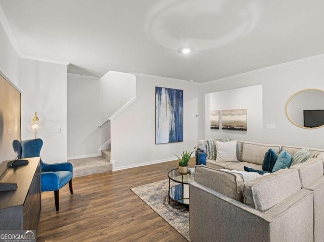 living room featuring crown molding, stairs, and wood finished floors