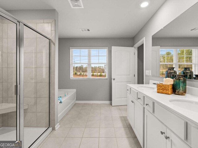 full bathroom featuring a wealth of natural light, a stall shower, and visible vents