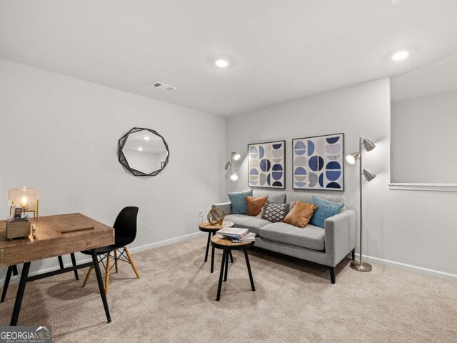 living room featuring baseboards, visible vents, recessed lighting, and light colored carpet