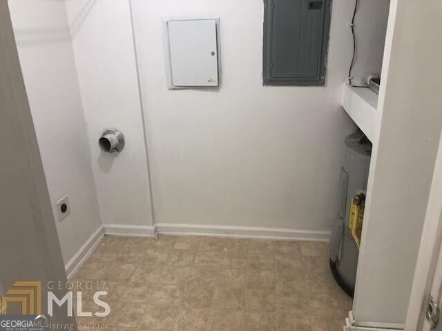 laundry area featuring baseboards, laundry area, and electric panel