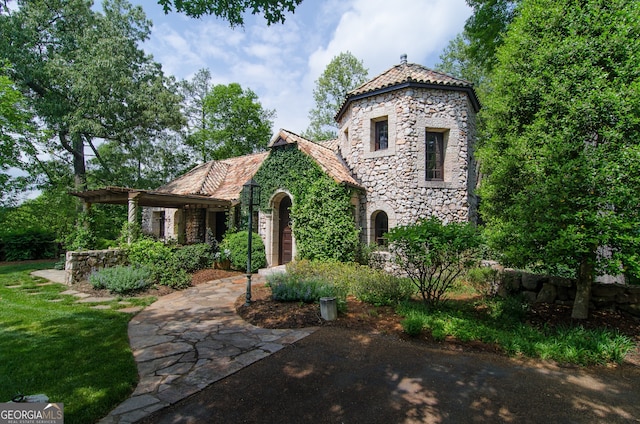 2100 W Wesley Rd, Atlanta, GA 30327 - view of front facade with stone siding and a high end roof