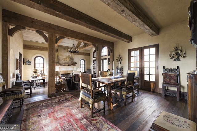 2100 W Wesley Rd, Atlanta, GA 30327 - dining room featuring french doors, beamed ceiling, wood-type flooring, a fireplace, and arched walkways