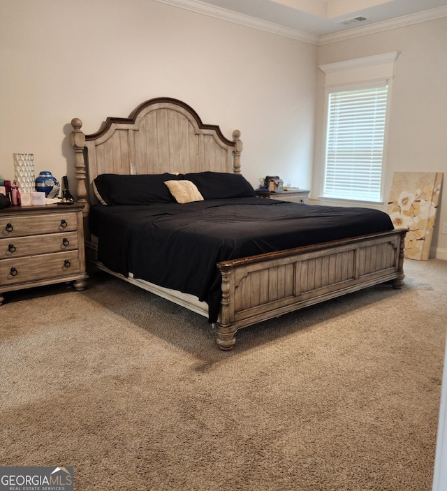 bedroom with carpet, visible vents, and ornamental molding