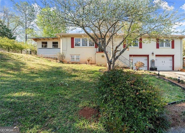view of front of property with a garage, stucco siding, driveway, and a front yard