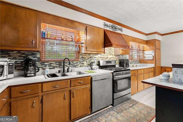 kitchen with a sink, light countertops, ornamental molding, and stainless steel appliances