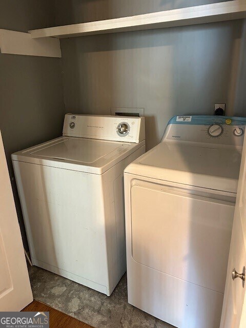 laundry area with washing machine and clothes dryer and laundry area