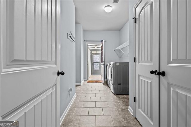 laundry area featuring washing machine and clothes dryer, baseboards, and laundry area