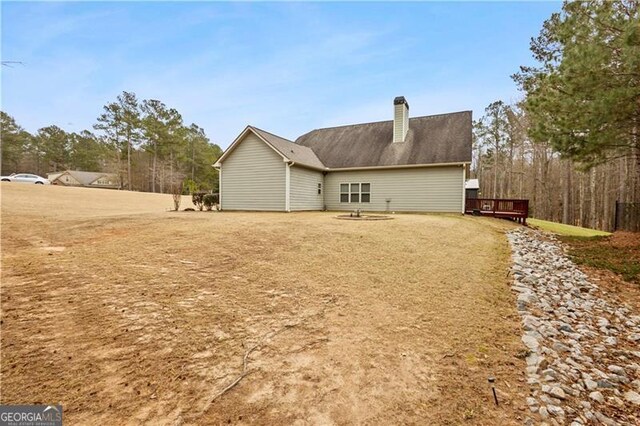 rear view of house featuring a chimney