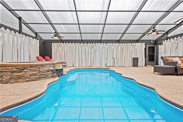 view of swimming pool featuring a ceiling fan, fence, and a patio