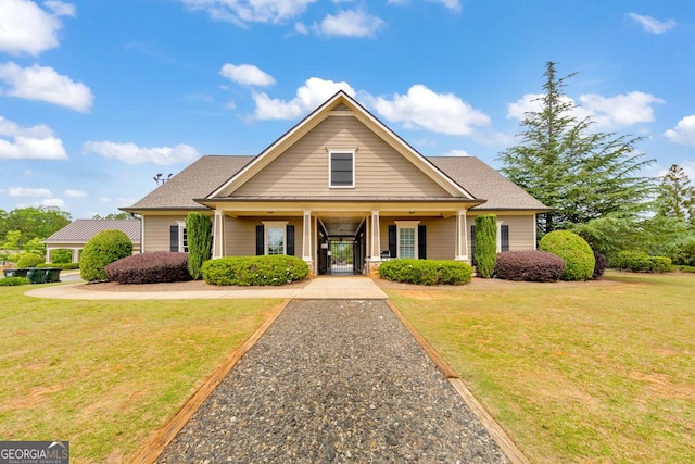 64 Durana Way, Dallas, GA 30132 - view of front facade with covered porch, a front yard, and roof with shingles