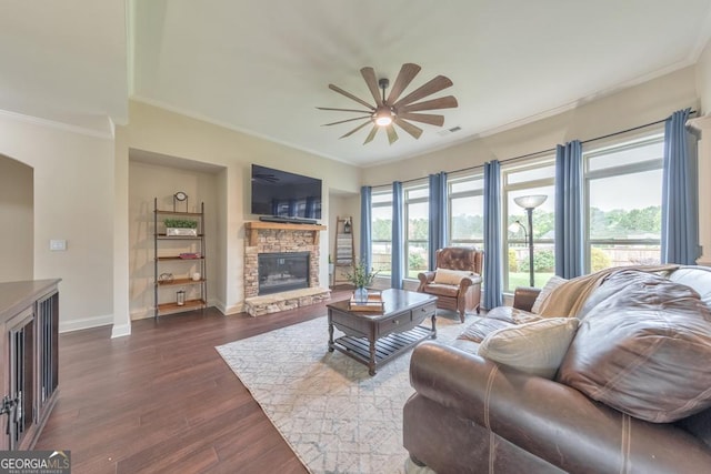 64 Durana Way, Dallas, GA 30132 - living area with ornamental molding, a ceiling fan, a stone fireplace, dark wood-type flooring, and arched walkways