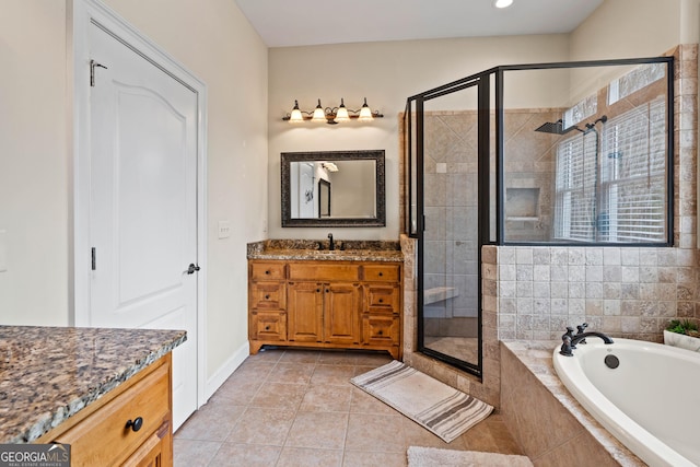 full bath with a shower stall, tile patterned flooring, vanity, and a bath