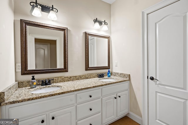 full bathroom featuring double vanity and a sink
