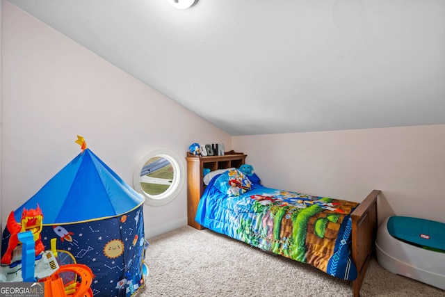 carpeted bedroom with baseboards and lofted ceiling