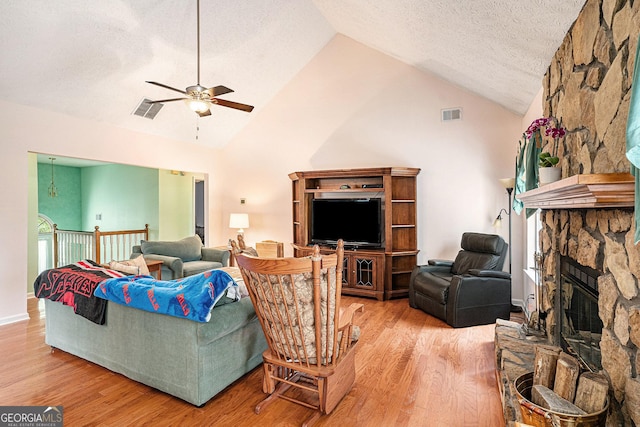 living room featuring a ceiling fan, light wood-style flooring, and visible vents