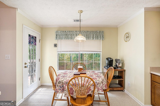 dining space with baseboards, ornamental molding, a textured ceiling, and visible vents