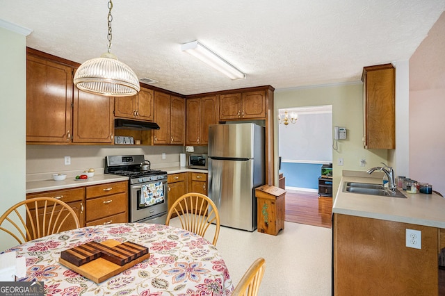 kitchen with a sink, appliances with stainless steel finishes, under cabinet range hood, and light countertops