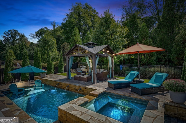 319 Riverton Way, Woodstock, GA 30188 - pool at dusk with an outdoor living space, a gazebo, a patio area, and a fenced backyard