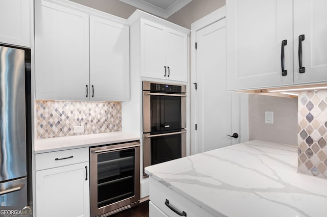 319 Riverton Way, Woodstock, GA 30188 - kitchen with beverage cooler, appliances with stainless steel finishes, backsplash, and white cabinetry