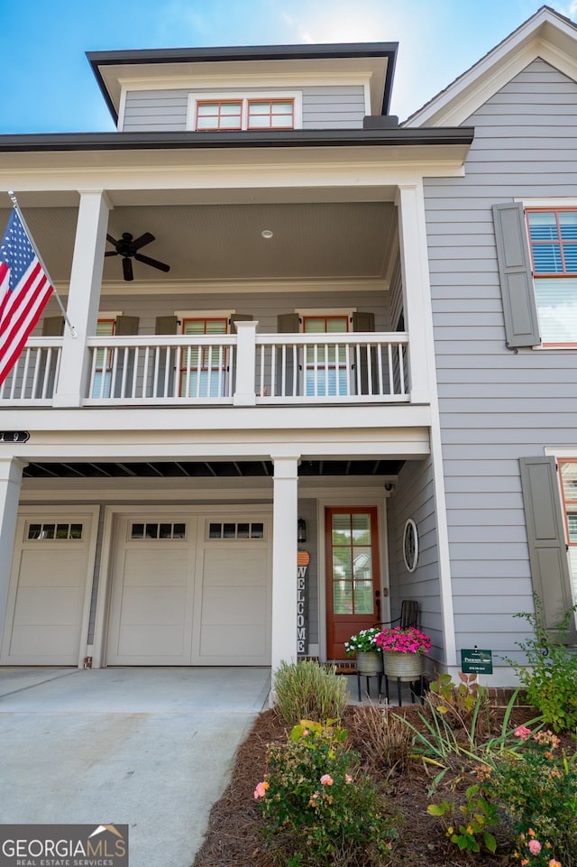 319 Riverton Way, Woodstock, GA 30188 - view of front of property featuring a balcony, a garage, driveway, and a ceiling fan