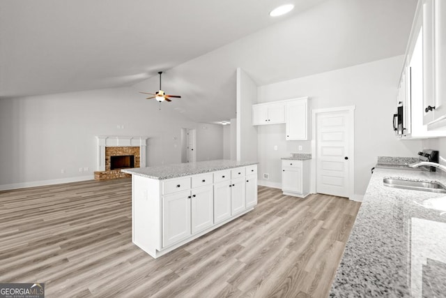 445 Liberty Hill Rd Unit 22, Hartwell, GA 30643 - kitchen with white cabinetry, light wood-style floors, ceiling fan, and a sink