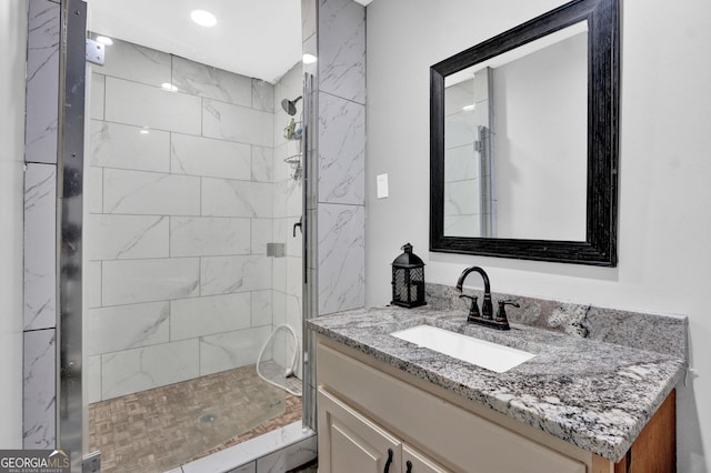 bathroom featuring a shower stall and vanity